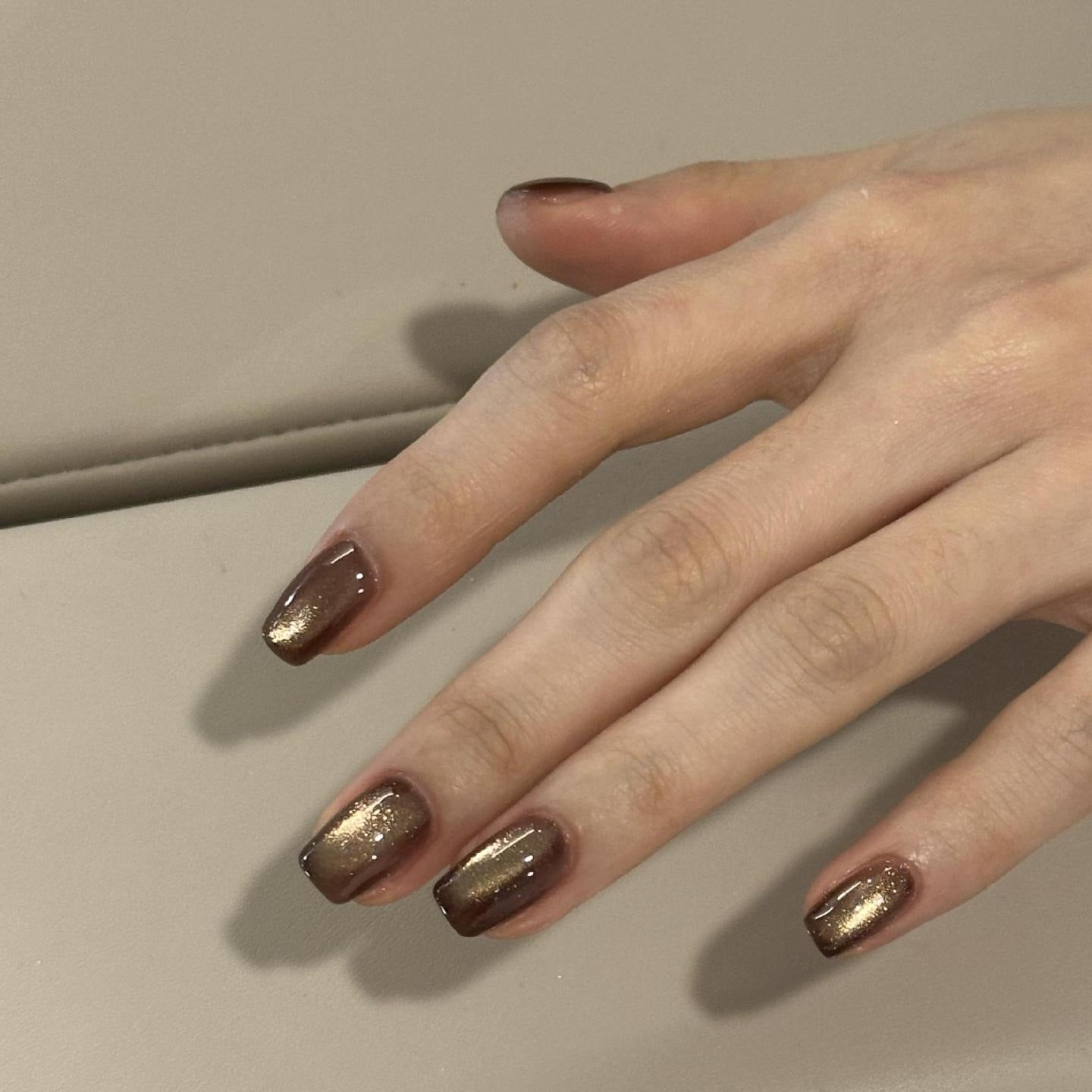 Gold cat-eye short-square press-on nails with chocolate-brown edges