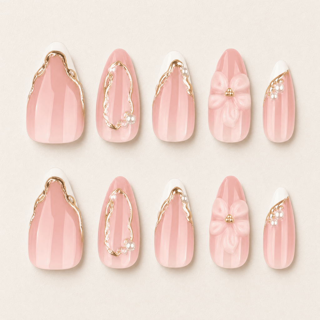 Blush-pink almond press-on nails with white flowers and gold details