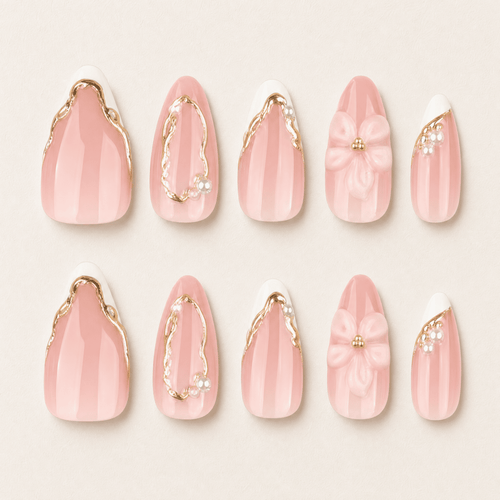 Blush-pink almond press-on nails with white flowers and gold details