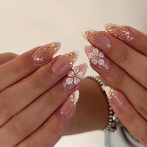 Blush-pink almond press-on nails with white flowers and gold details