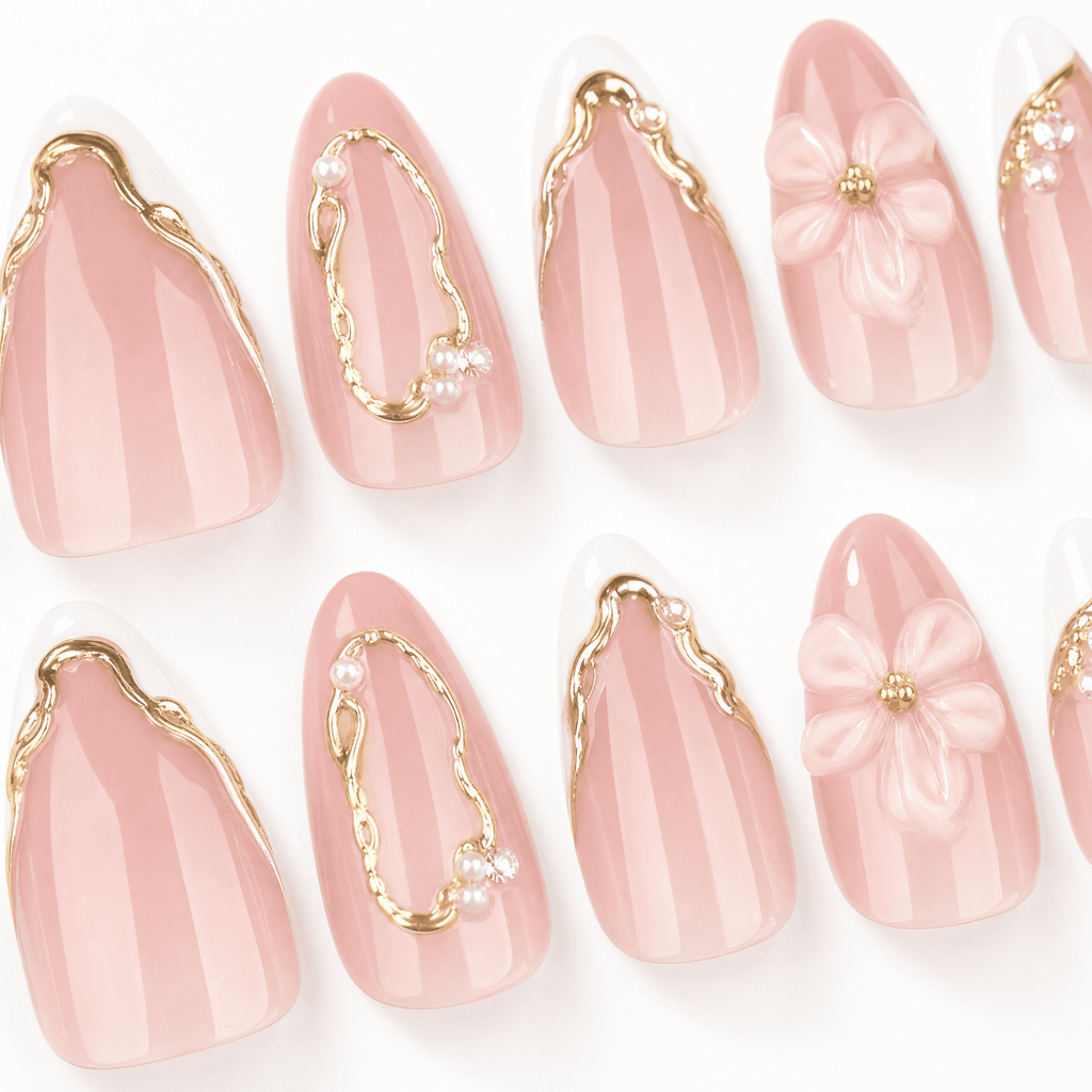 Blush-pink almond press-on nails with white flowers and gold details