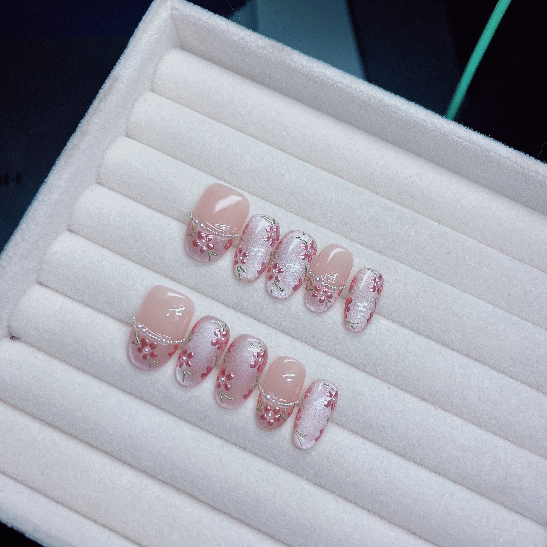 Pink floral cat-eye press-on nails with pearl and translucent details
