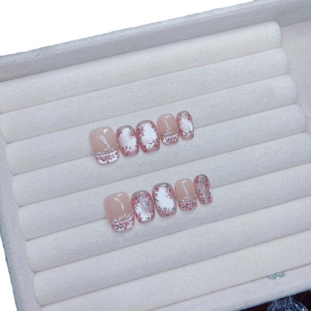 Pink floral cat-eye press-on nails with pearl and translucent details