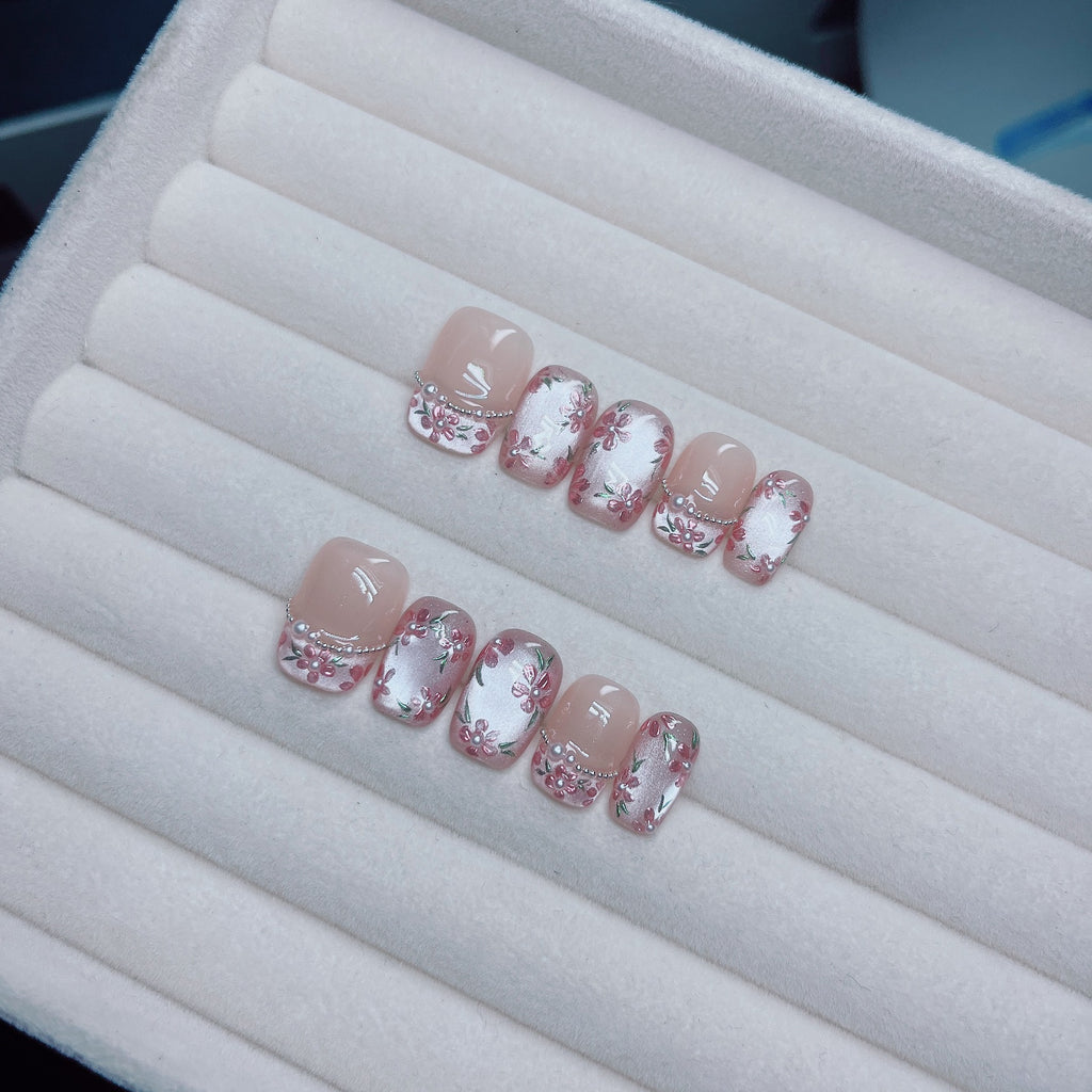 Pink floral cat-eye press-on nails with pearl and translucent details