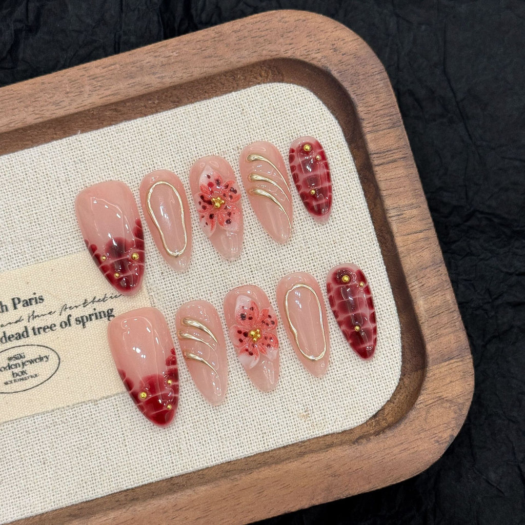 Burgundy floral almond press-on nails worn on one handburgundy-bloom-almond-press-on-nails-0