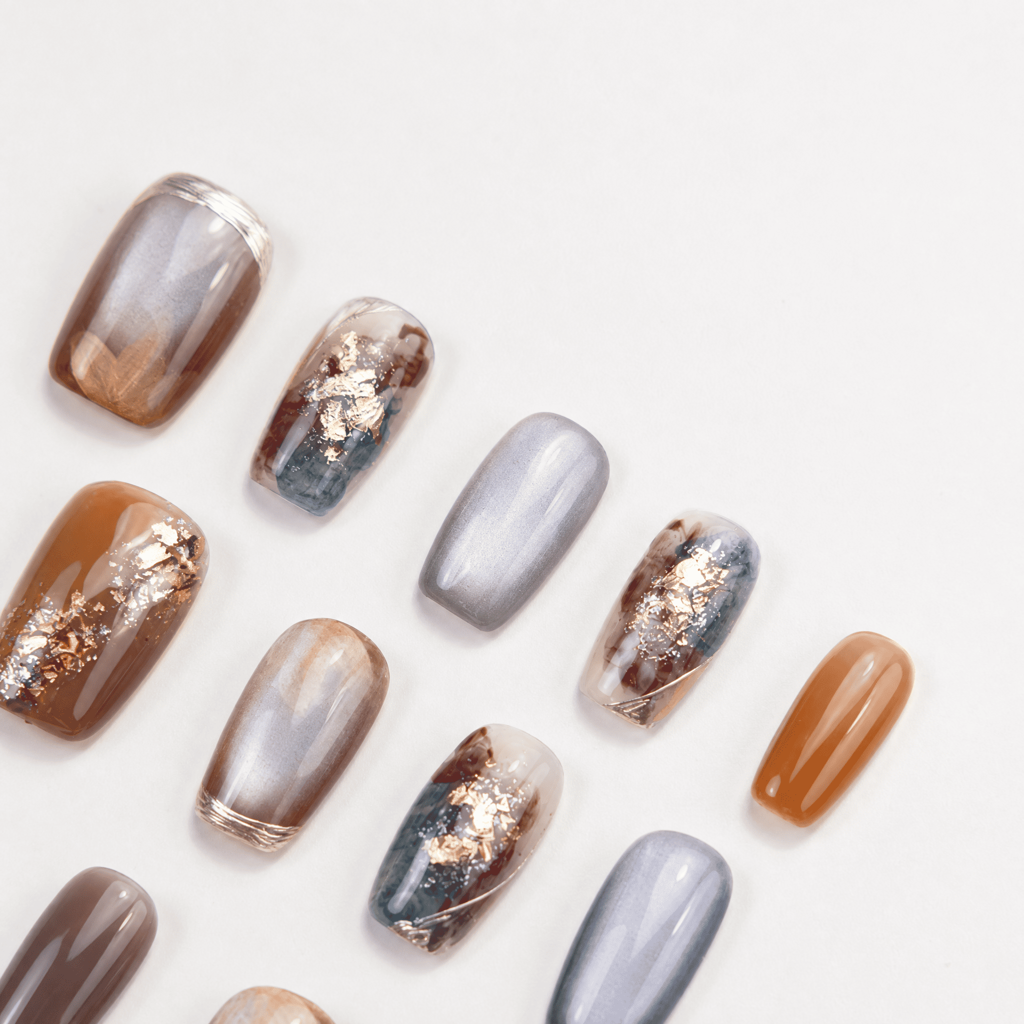 Caramel and smoky-grey cat-eye marble press-on nails with gold foil