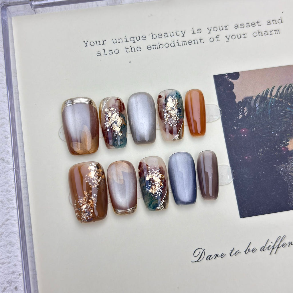 Caramel and smoky-grey cat-eye marble press-on nails with gold foil