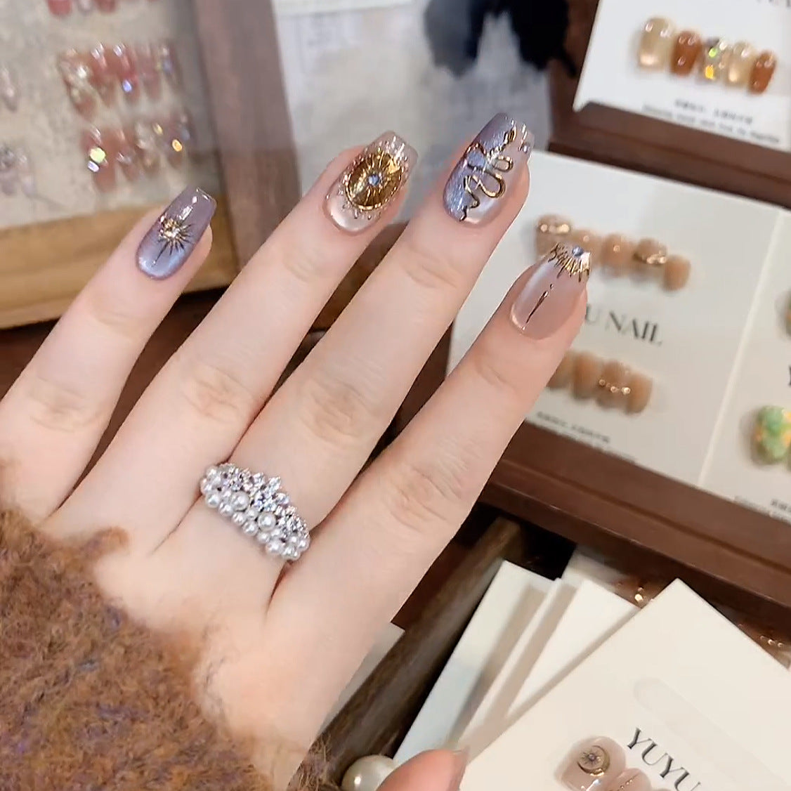 Celestial Baroque press-on nails with gold moon and serpent details