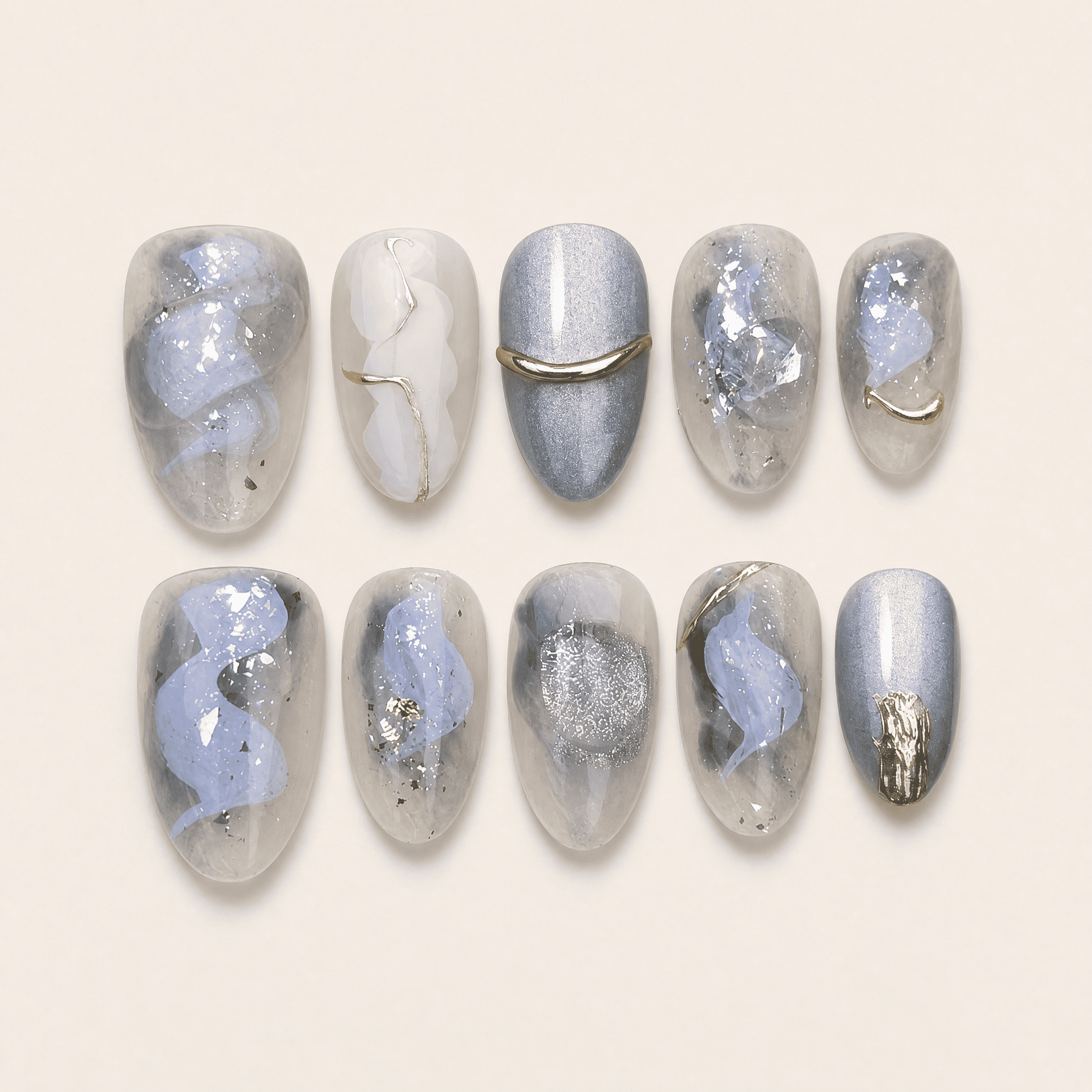 Icy blue and silver cat-eye press-on nails with gold accents