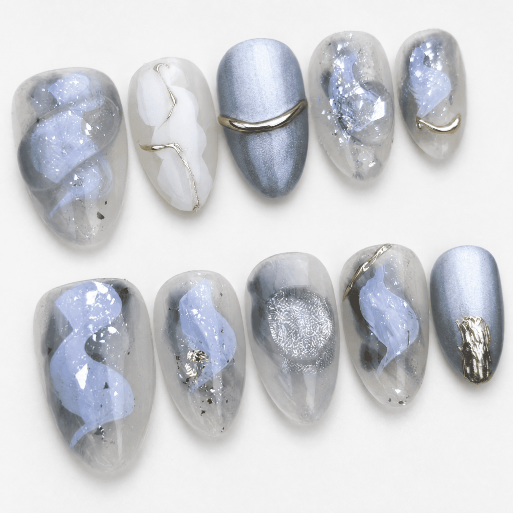 Icy blue and silver cat-eye press-on nails with gold accents