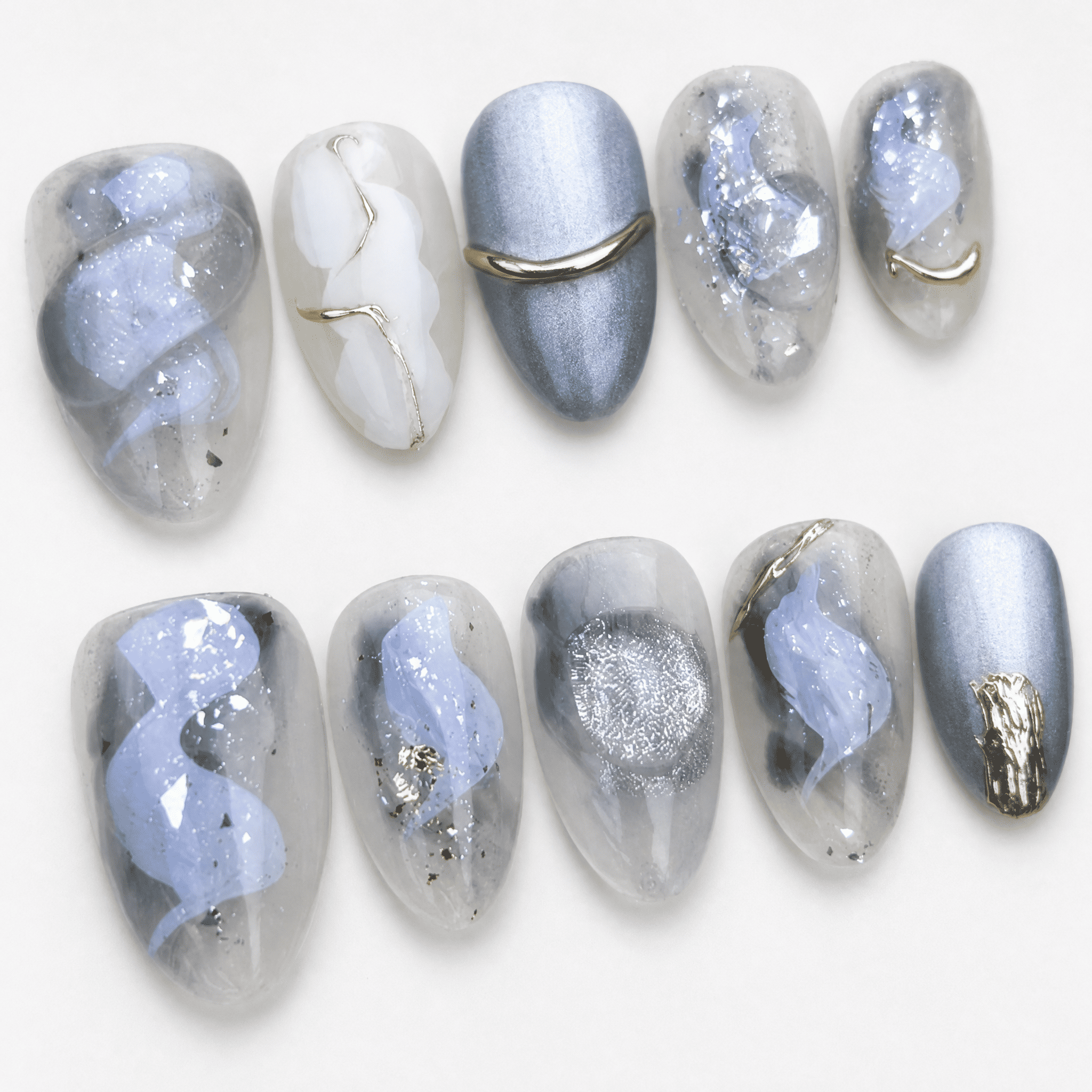 Icy blue and silver cat-eye press-on nails with gold accents