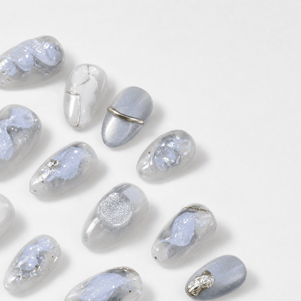 Icy blue and silver cat-eye press-on nails with gold accents