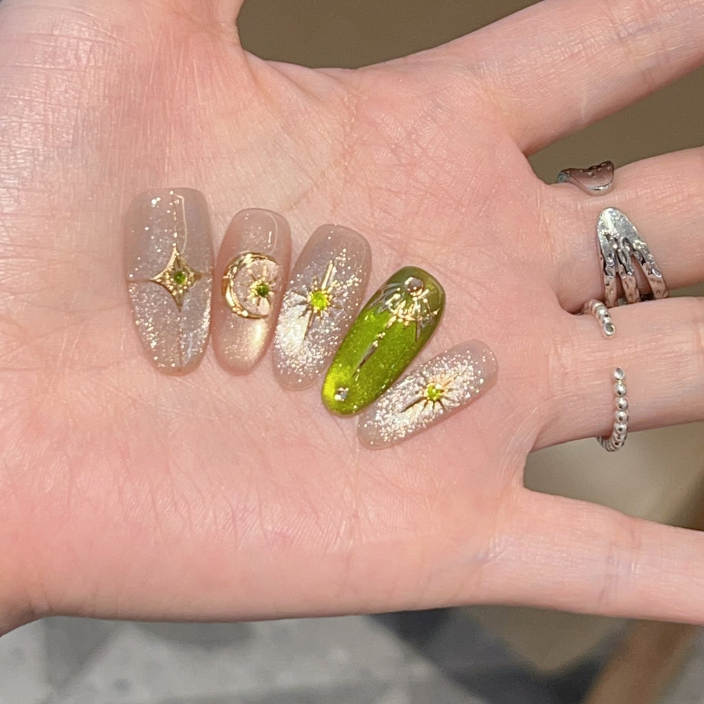 Green and gold short-square press-on nails with celestial designs