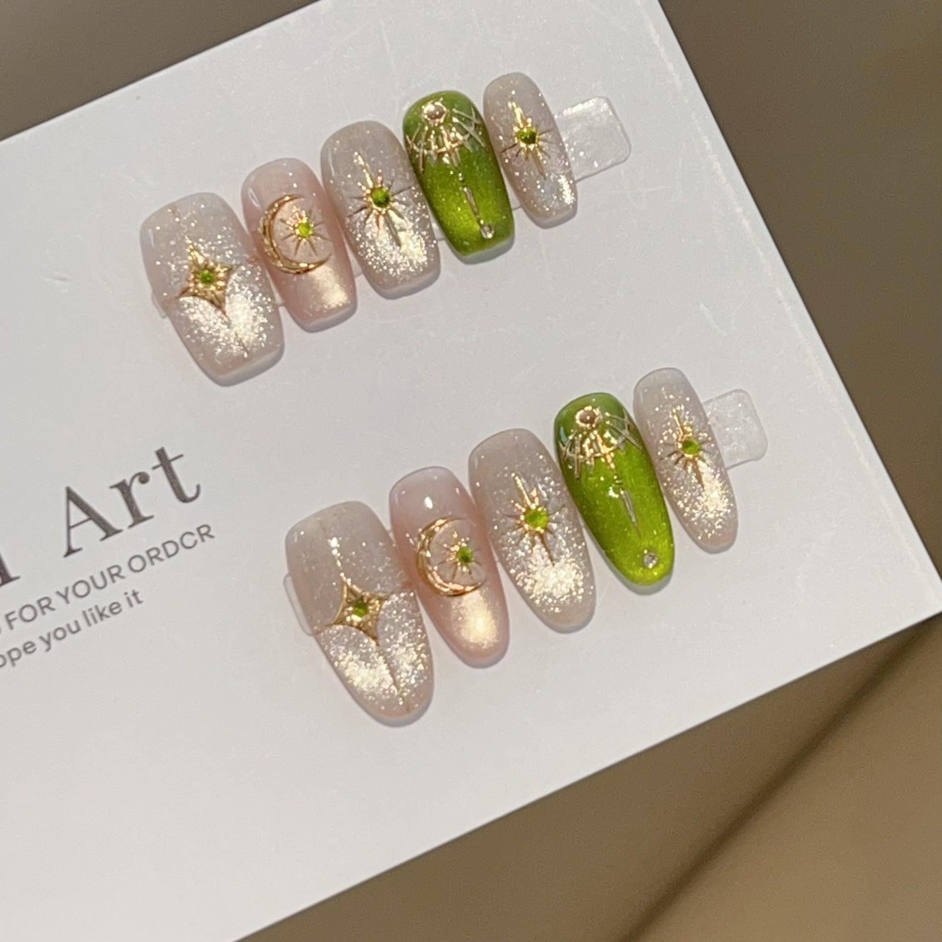 Green and gold short-square press-on nails with celestial designs
