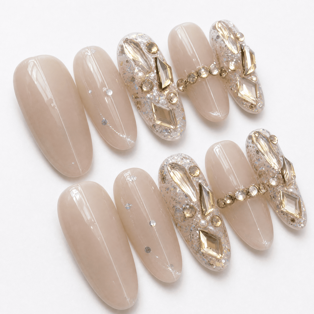 Nude oval cat-eye press-on nails with crystal and gold embellishments