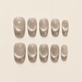 Champagne cat-eye press-on nails with silver glitter French tips
