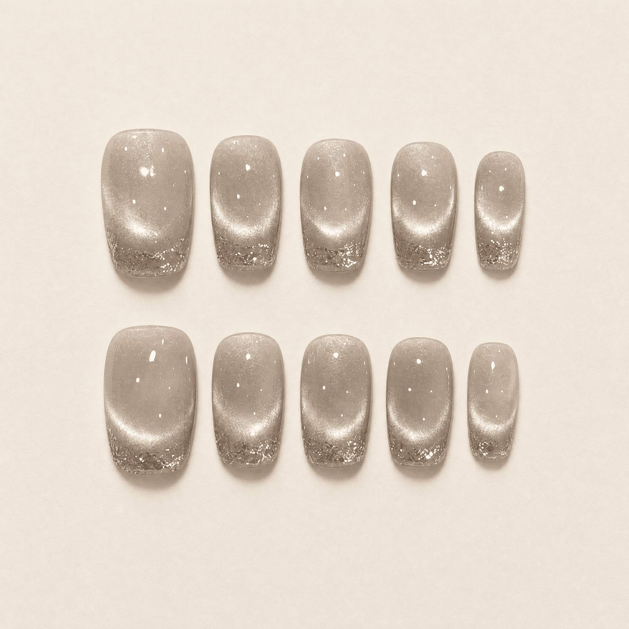Champagne cat-eye press-on nails with silver glitter French tips