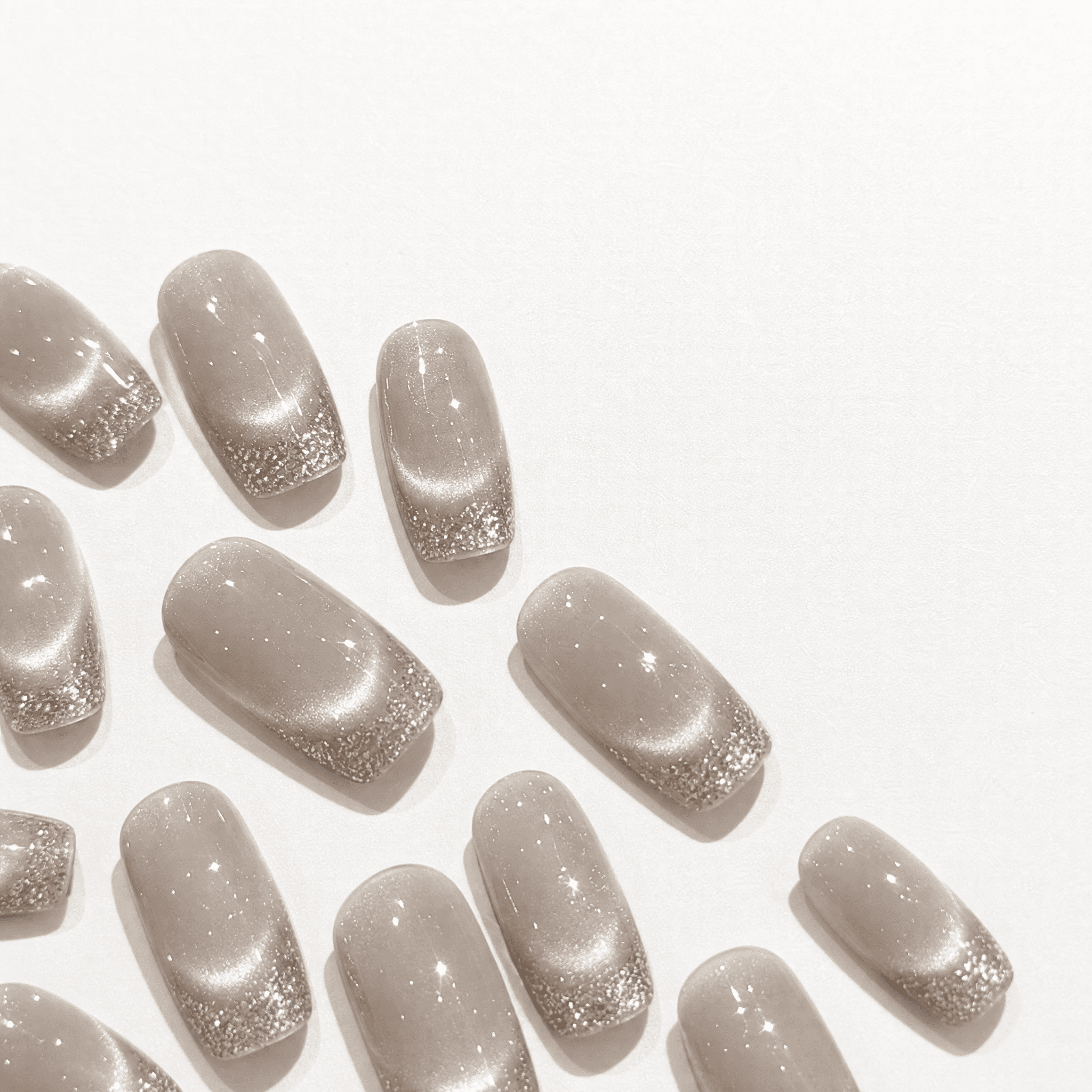 Champagne cat-eye press-on nails with silver glitter French tips