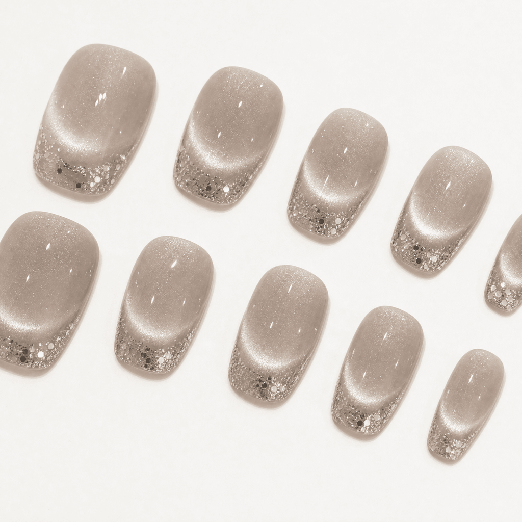 Champagne cat-eye press-on nails with silver glitter French tips