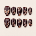 Burgundy short almond press-on nails with shimmering butterfly artwork