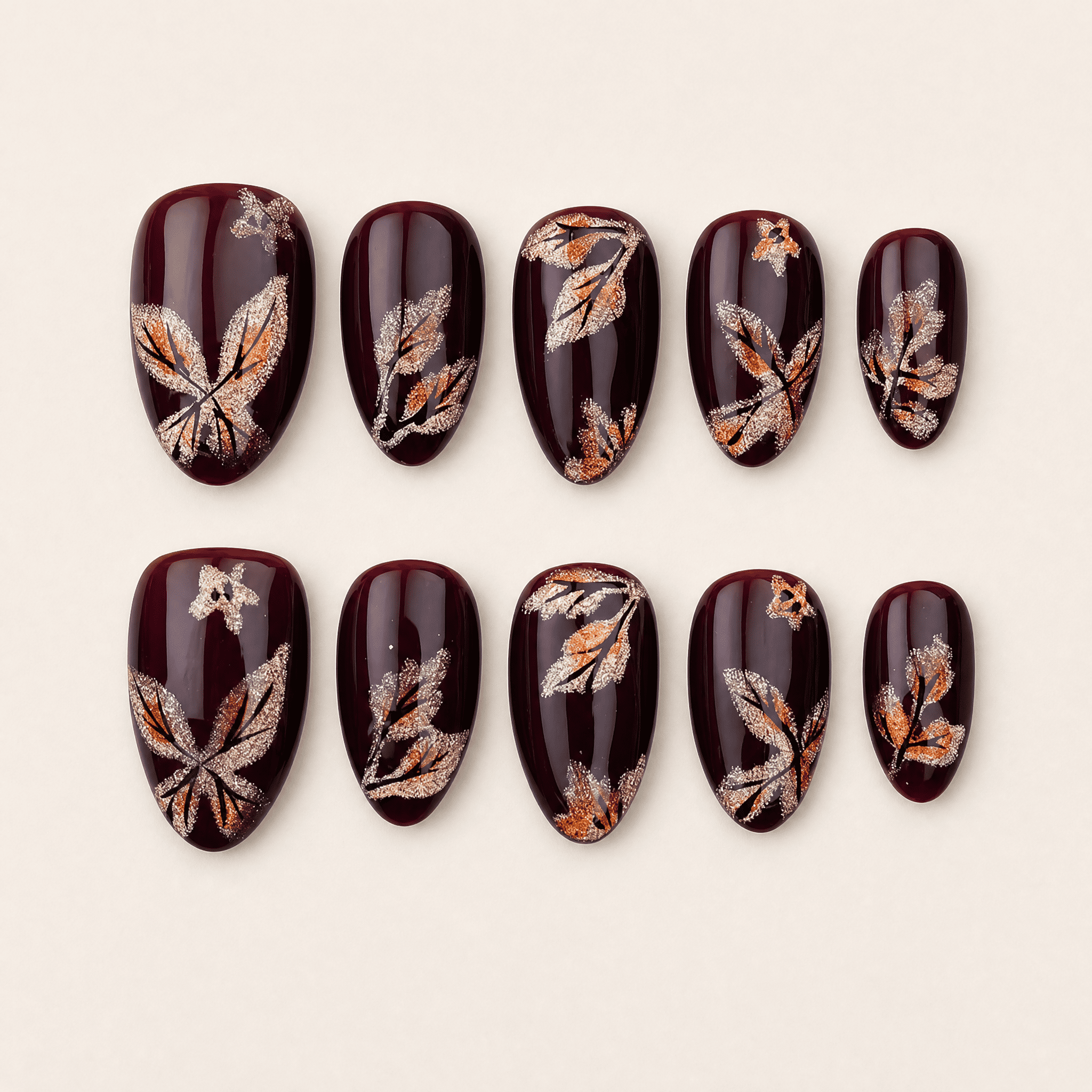 Burgundy short almond press-on nails with shimmering butterfly artwork