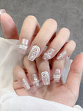 Blush crystal tapered-square press-on nails worn on both hands