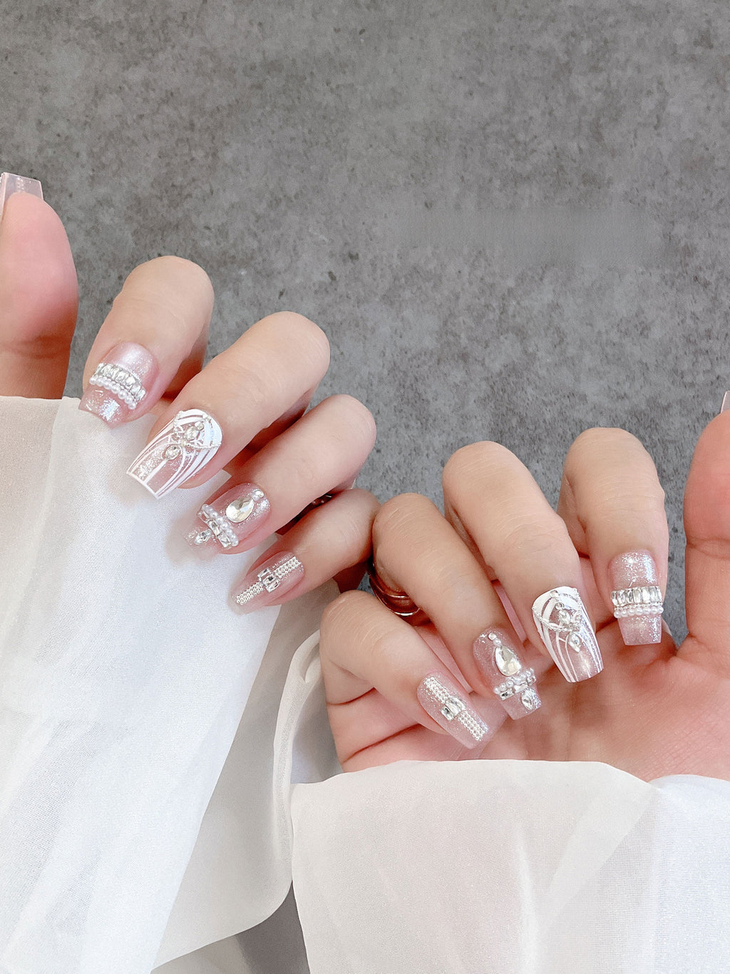 Blush crystal tapered-square press-on nails worn on both hands