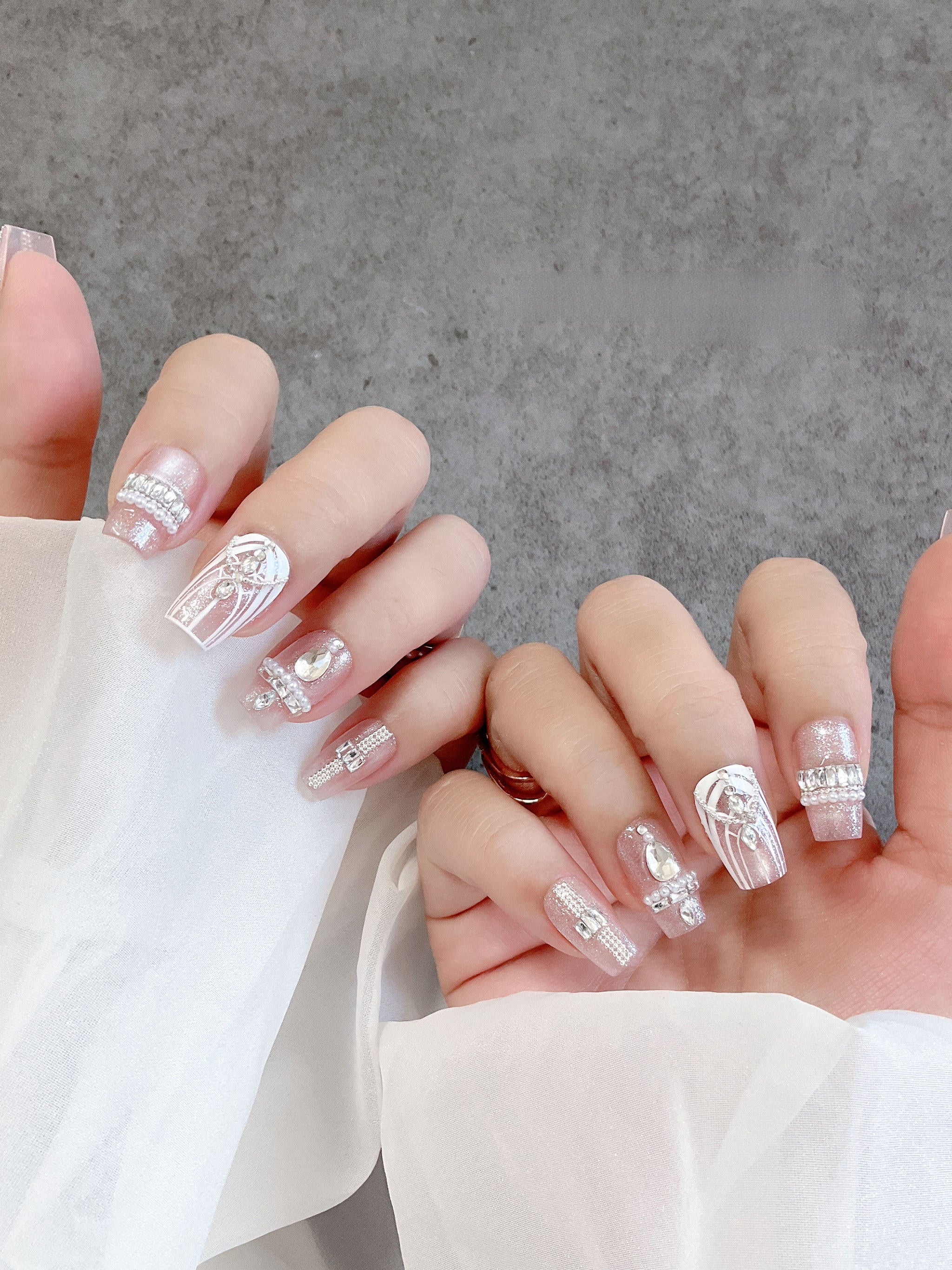 Blush crystal tapered-square press-on nails worn on both hands