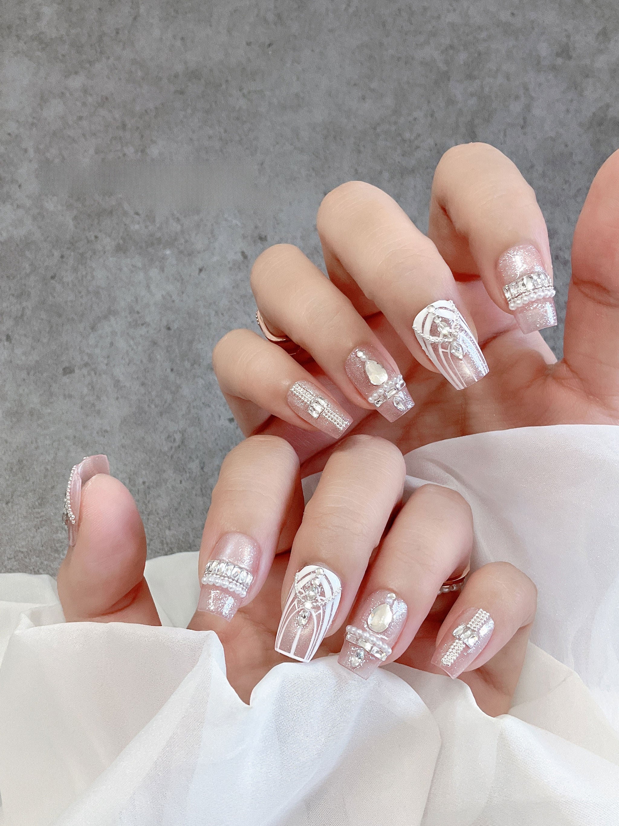 Blush crystal tapered-square press-on nails worn on both hands