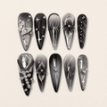 Black and silver 3D stiletto press-on nails with butterfly accents