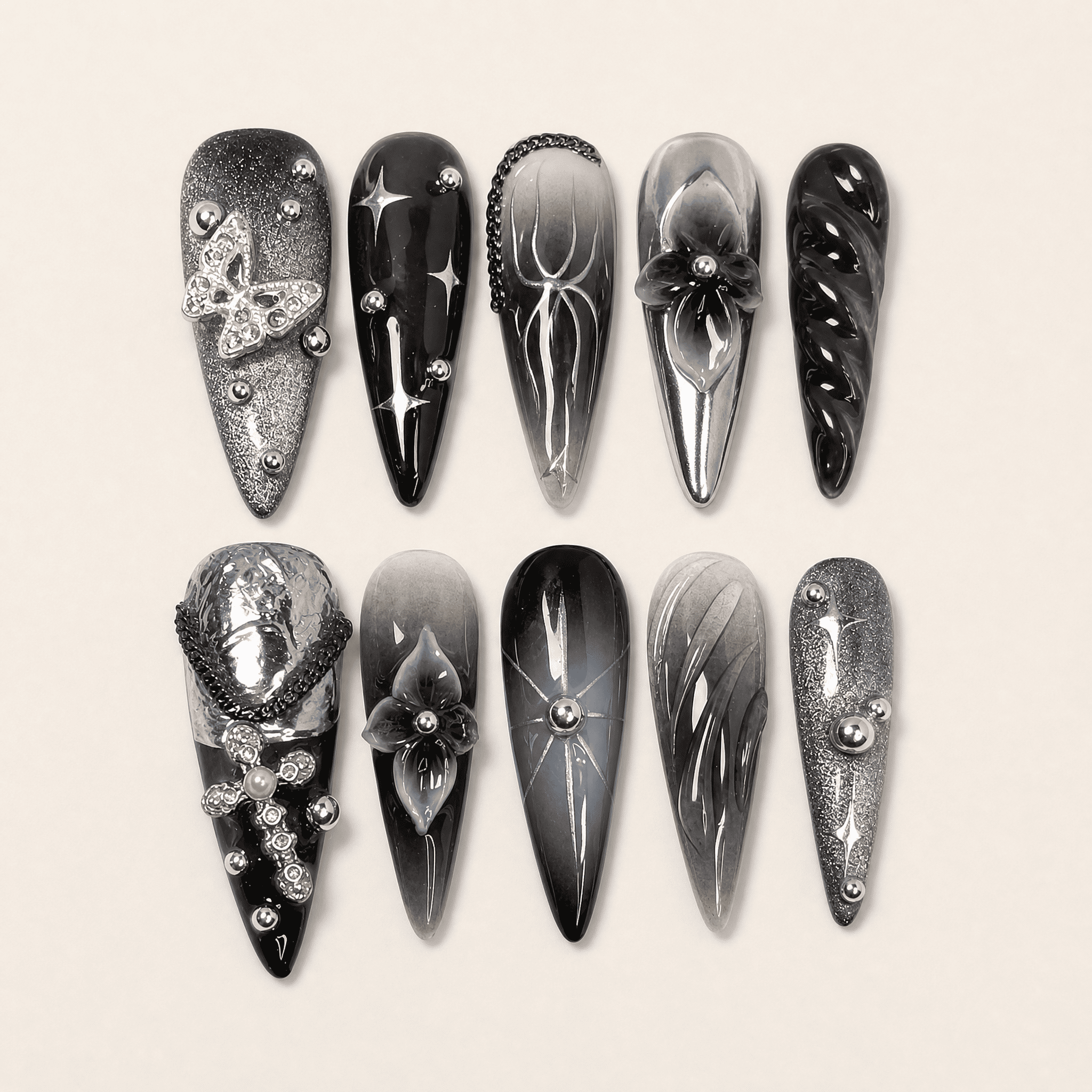 Black and silver 3D stiletto press-on nails with butterfly accents