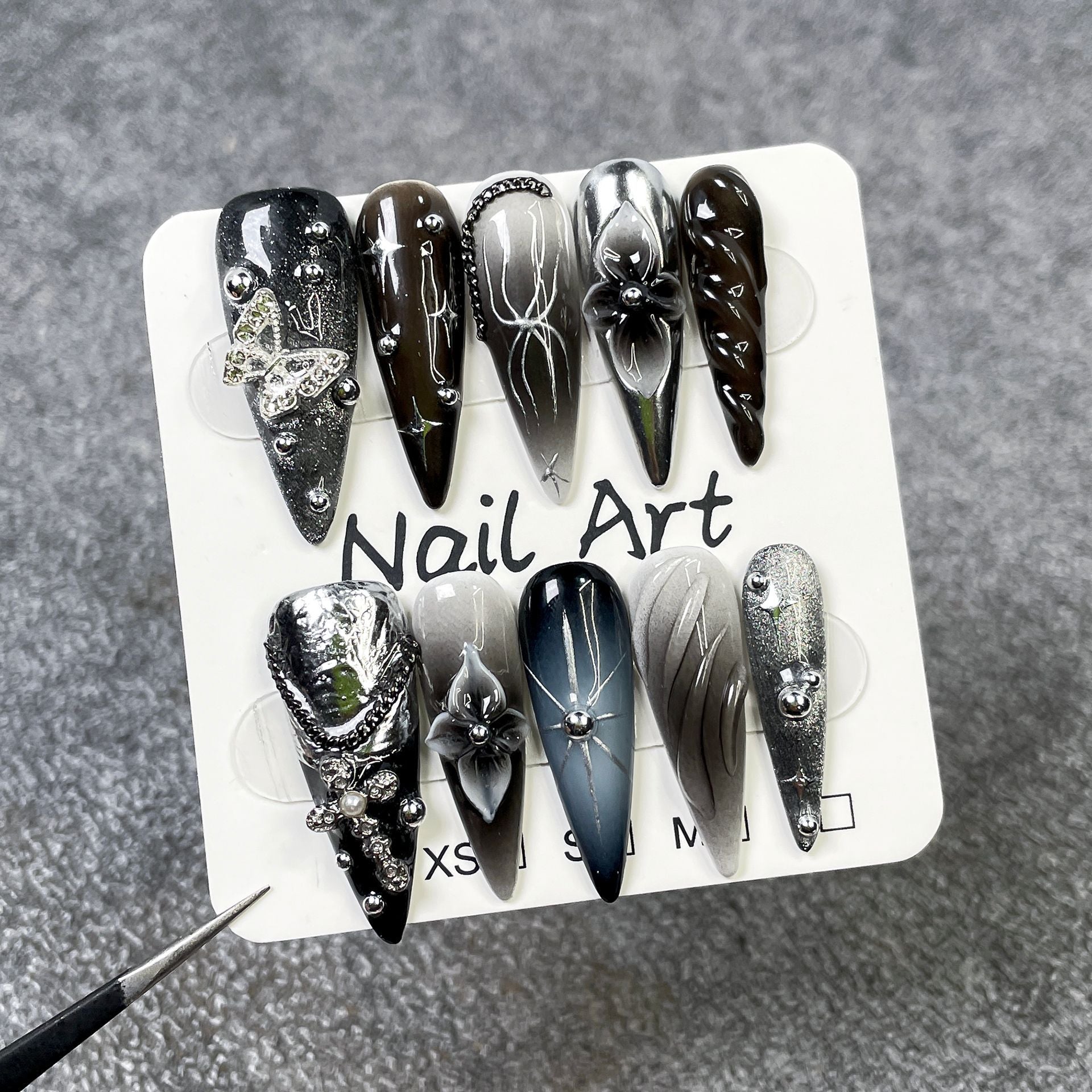Black and silver 3D stiletto press-on nails with butterfly accents