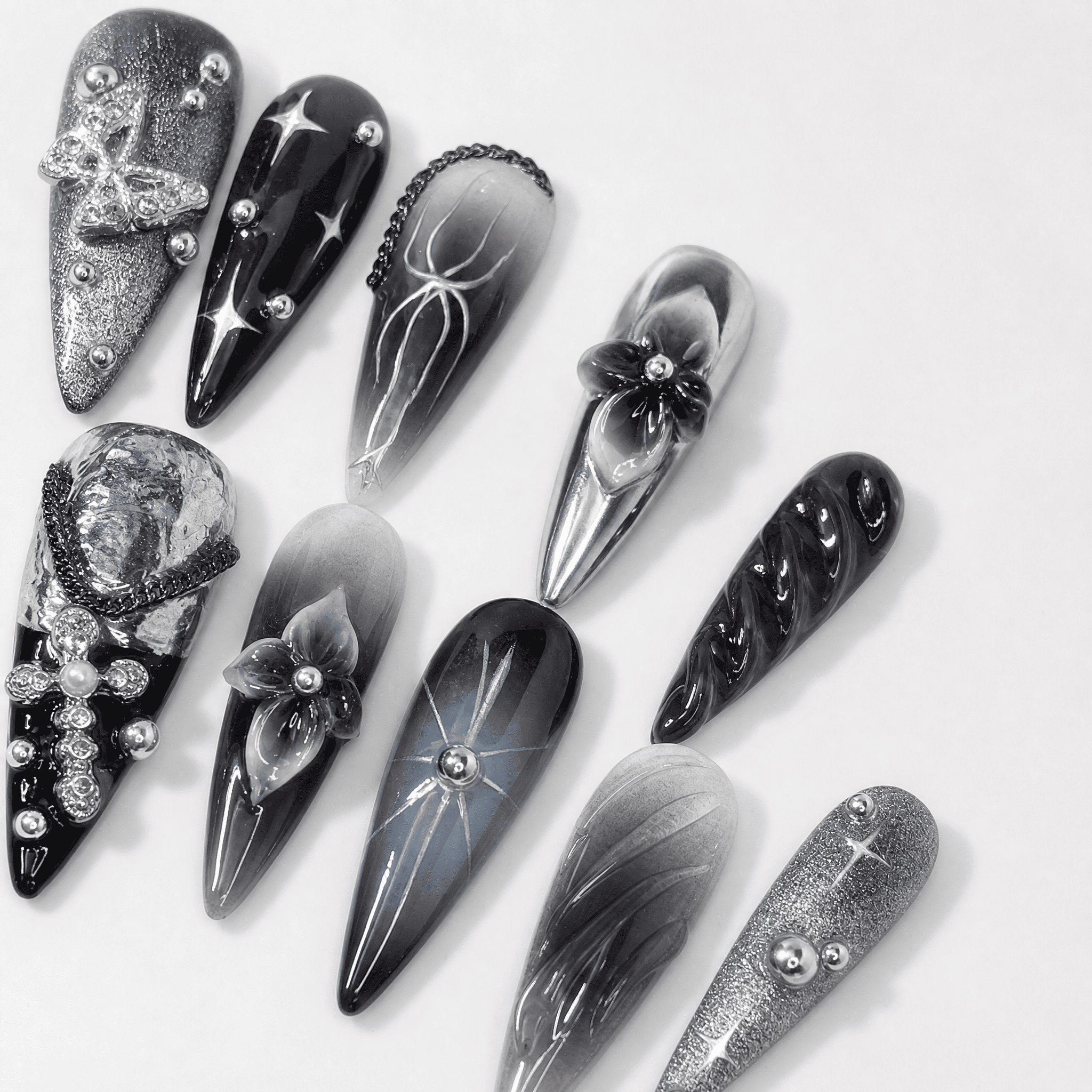 Black and silver 3D stiletto press-on nails with butterfly accents