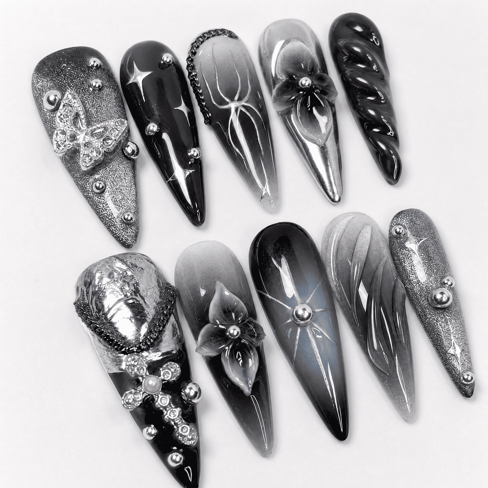 Black and silver 3D stiletto press-on nails with butterfly accents