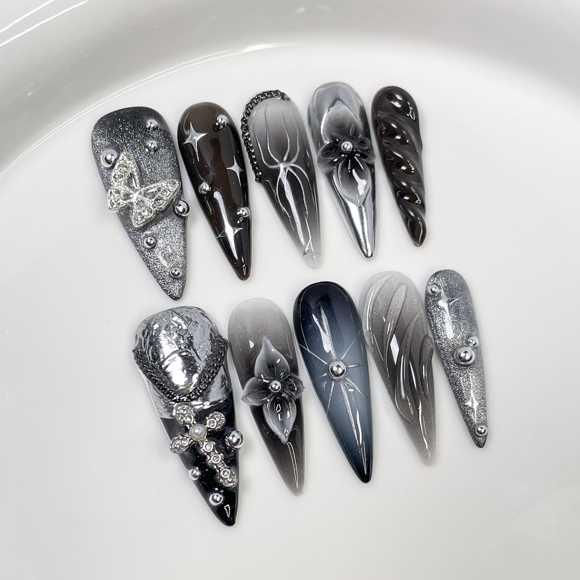 Black and silver 3D stiletto press-on nails with butterfly accents