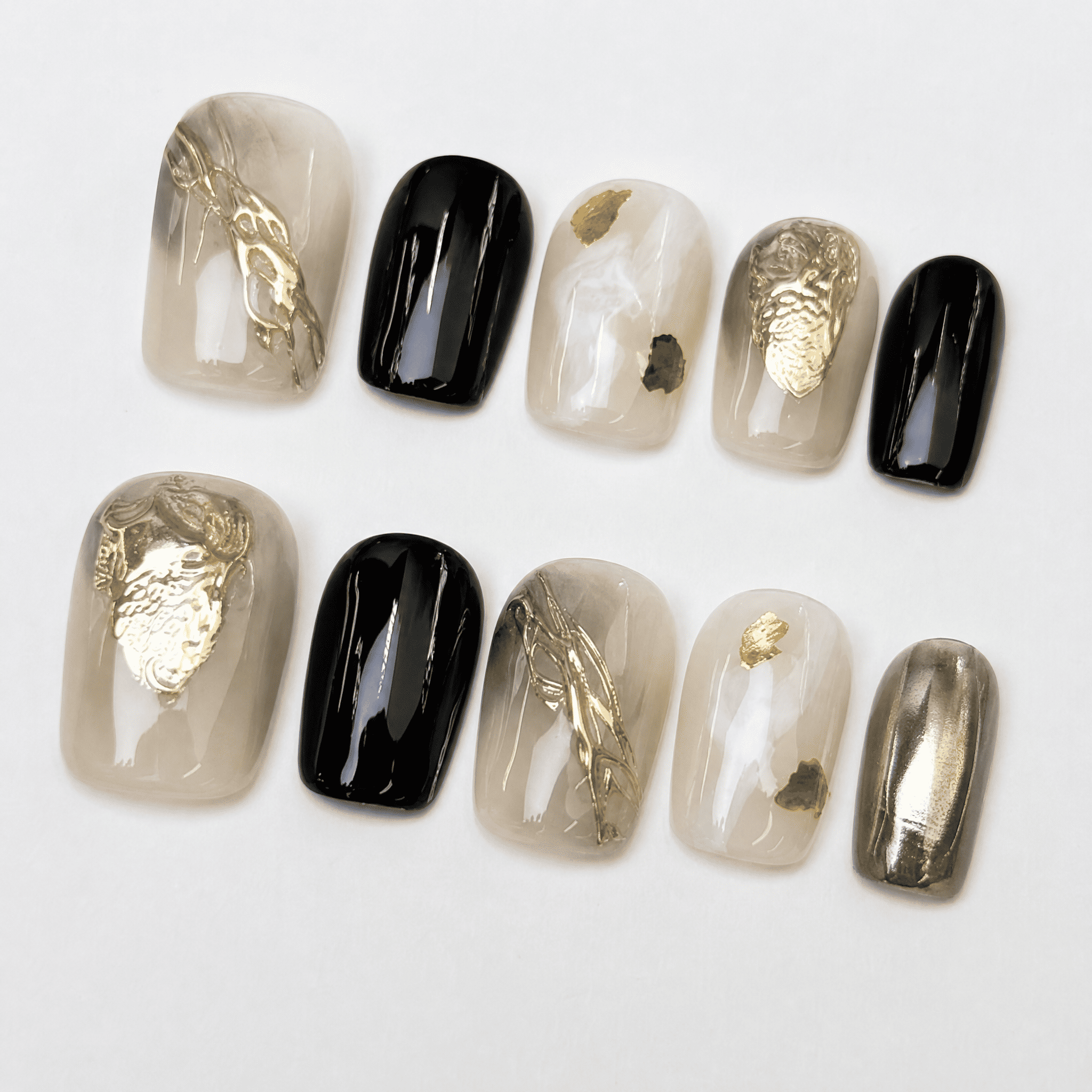 Black and gold short squoval press-on nails with smoky nude accents