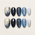 Blue cat-eye short almond press-on nails with black and marble designs