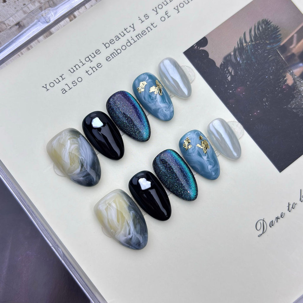 Blue cat-eye short almond press-on nails with black and marble designs