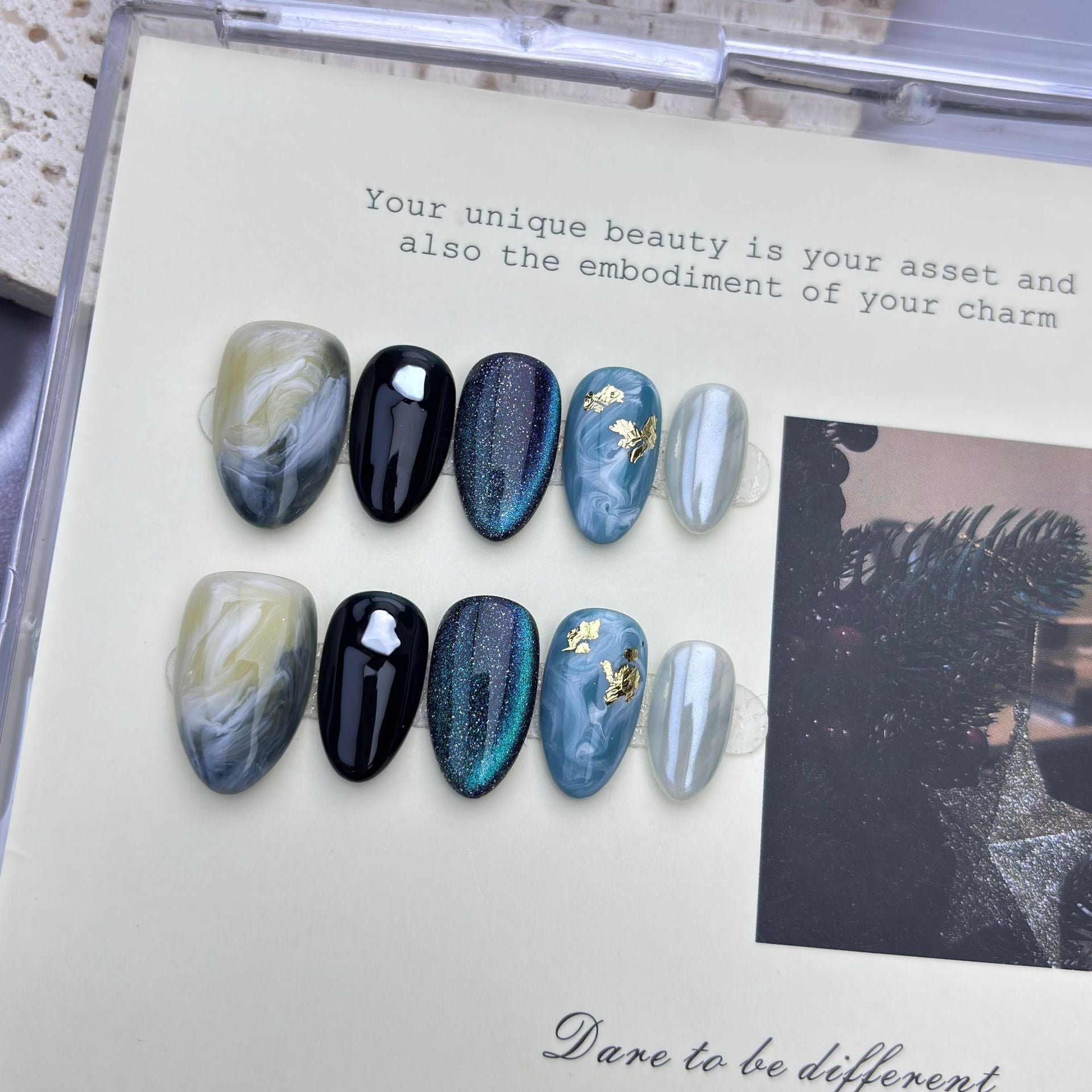 Blue cat-eye short almond press-on nails with black and marble designs