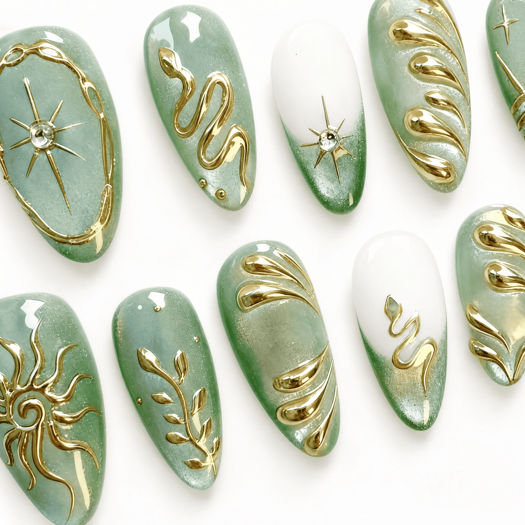 Thirty mint-green almond press-on nails with gold celestial designs