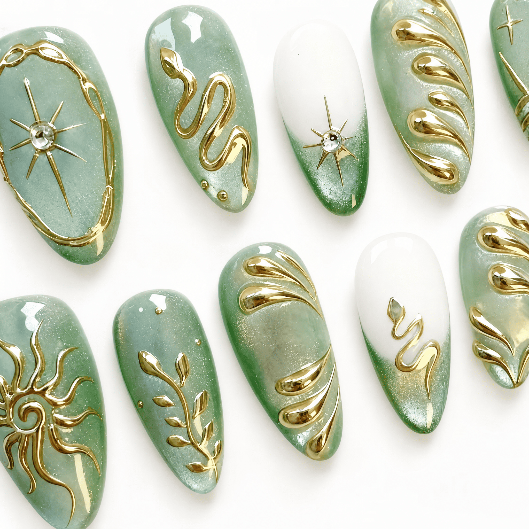 Thirty mint-green almond press-on nails with gold celestial designs