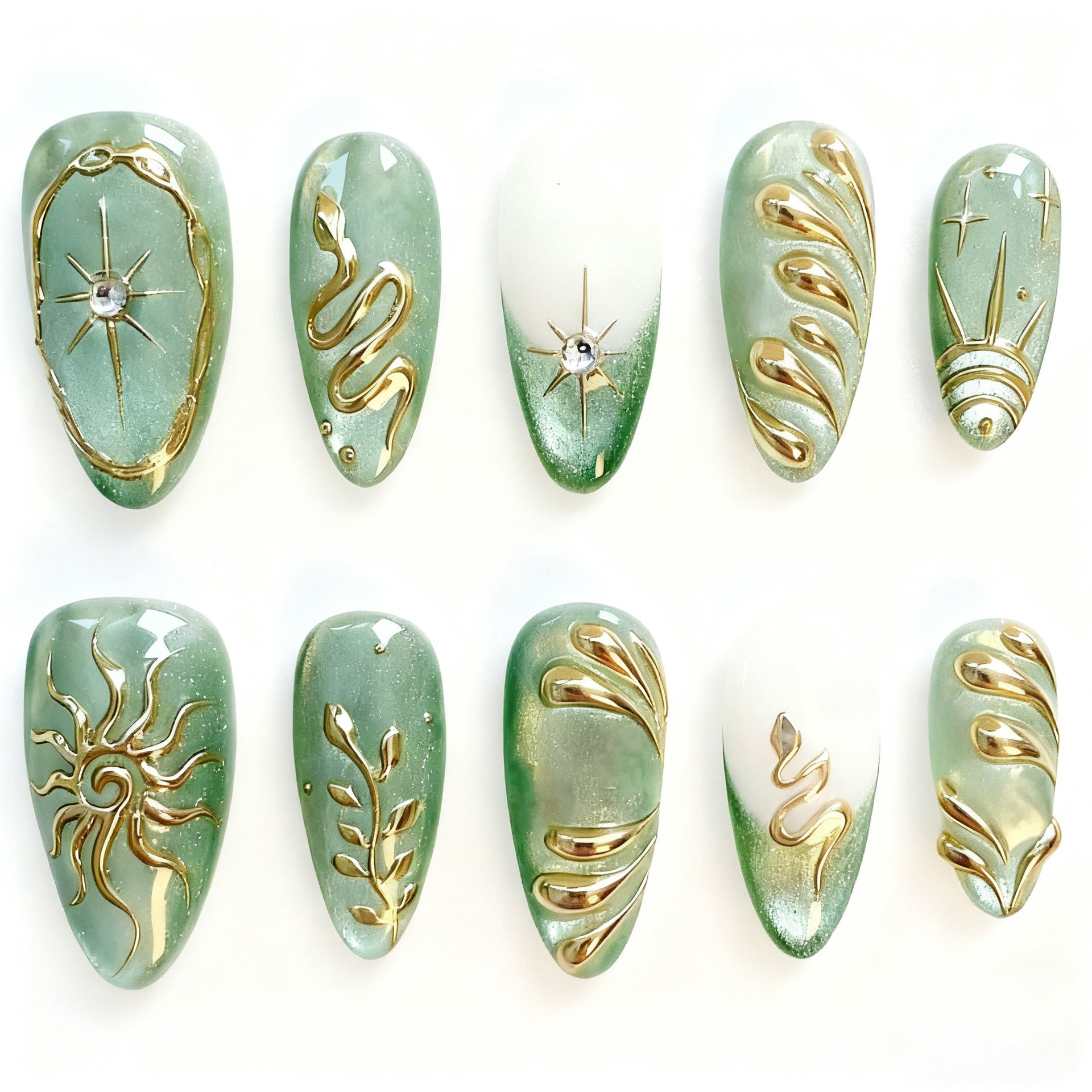 Thirty mint-green almond press-on nails with gold celestial designs