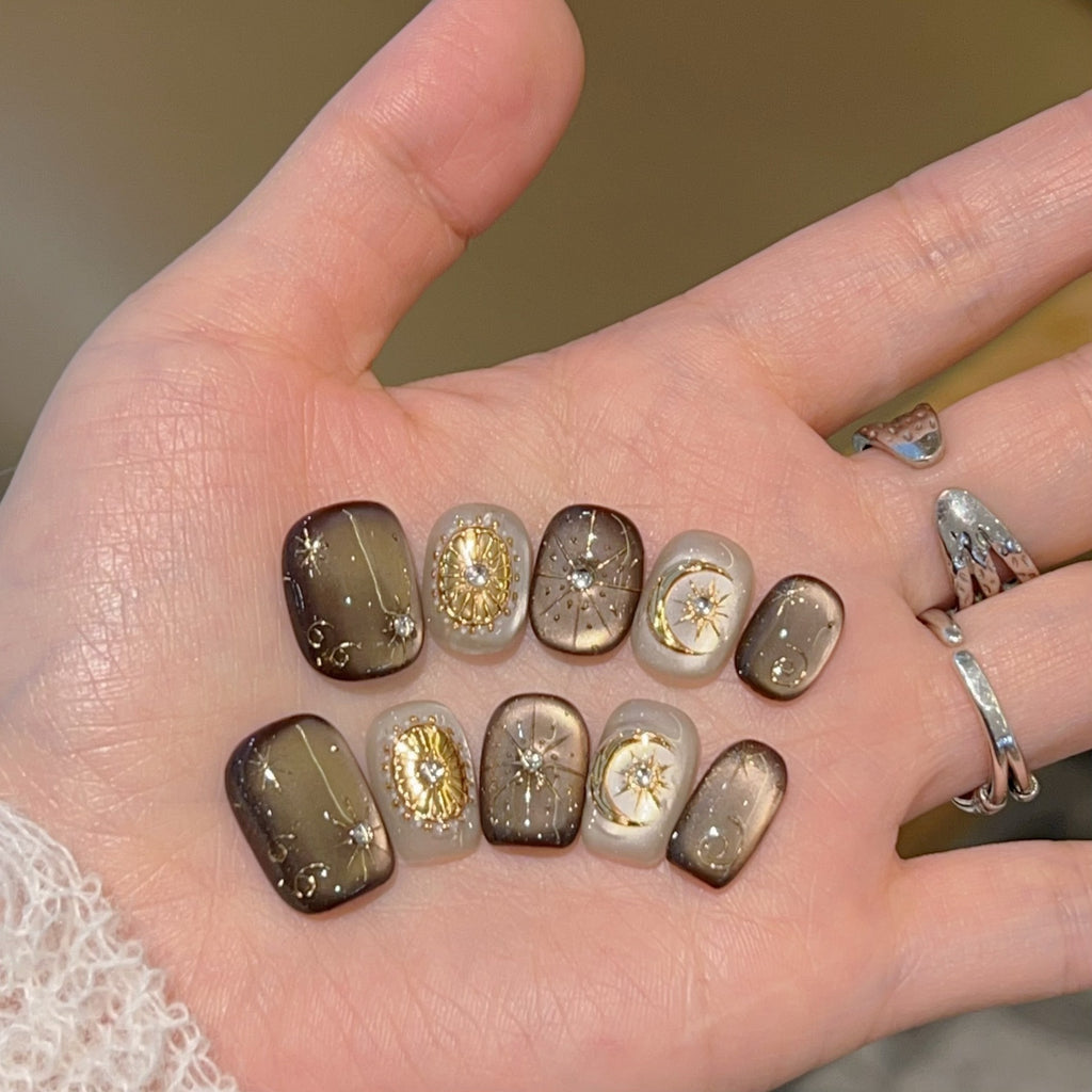 Mocha-brown celestial cat-eye press-on nails with gold details