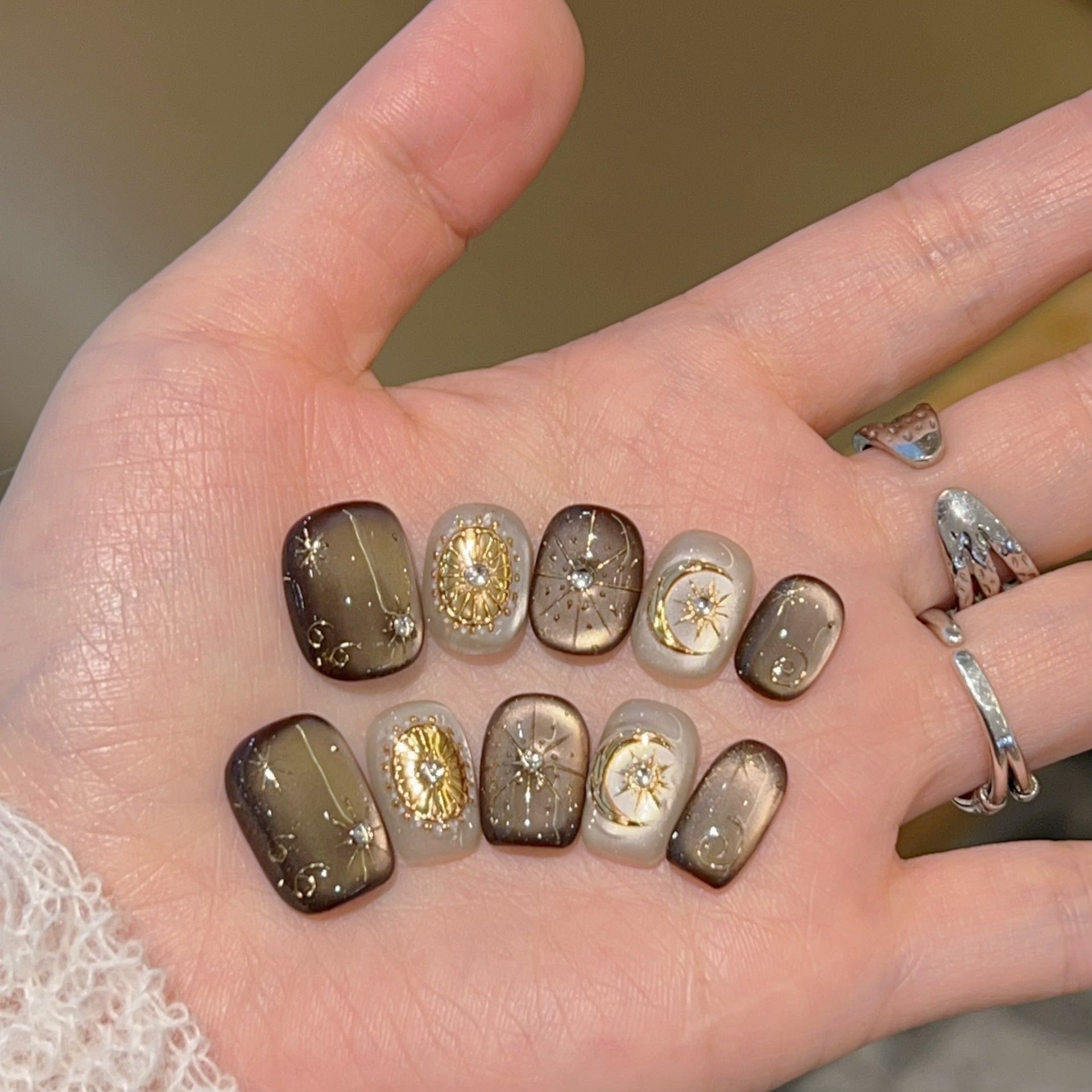 Mocha-brown celestial cat-eye press-on nails with gold details