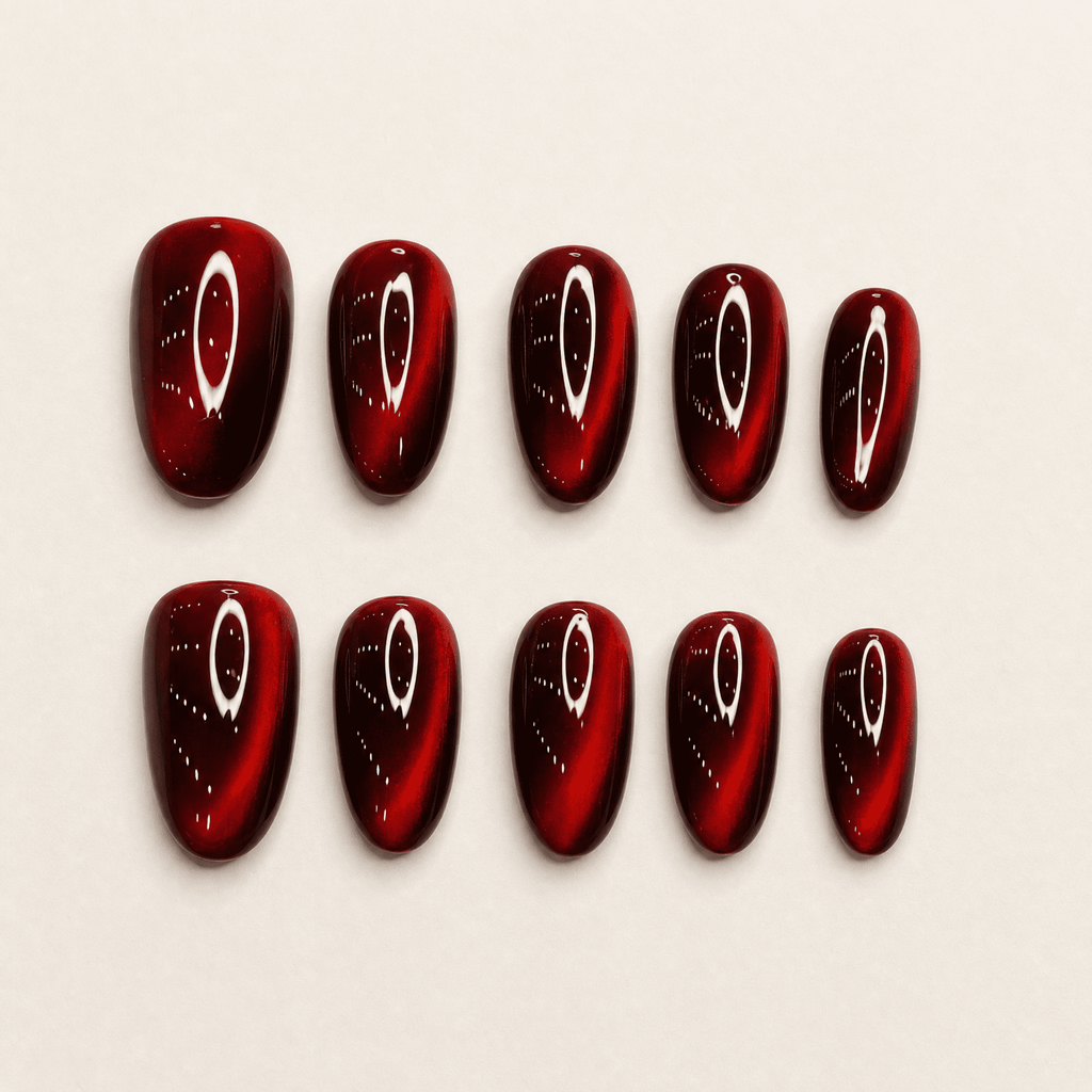 Ruby-red short-oval cat-eye press-on nails with reflective shimmer